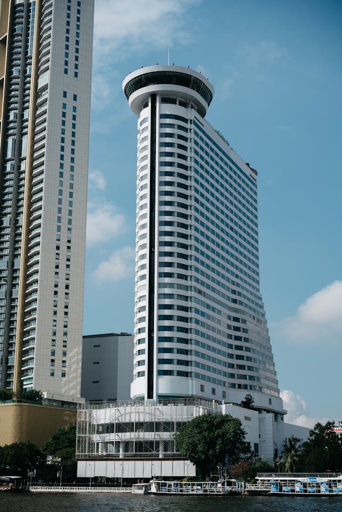 why-choose-us Skyscrapers in Bangkok with clear blue sky, showcasing modern architecture.